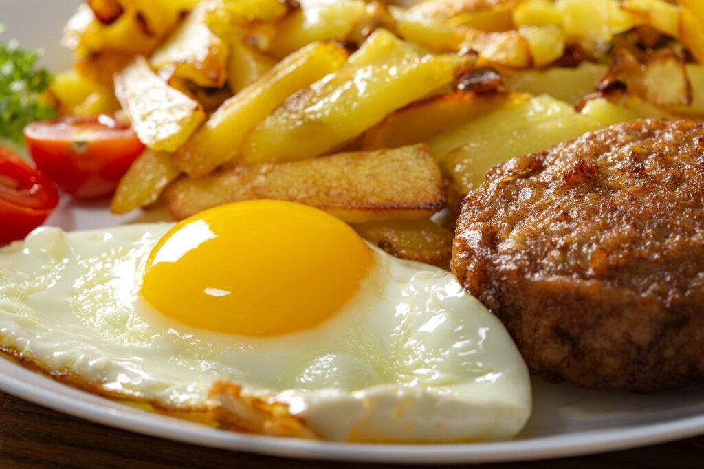 Fries with fried egg and one big meatball